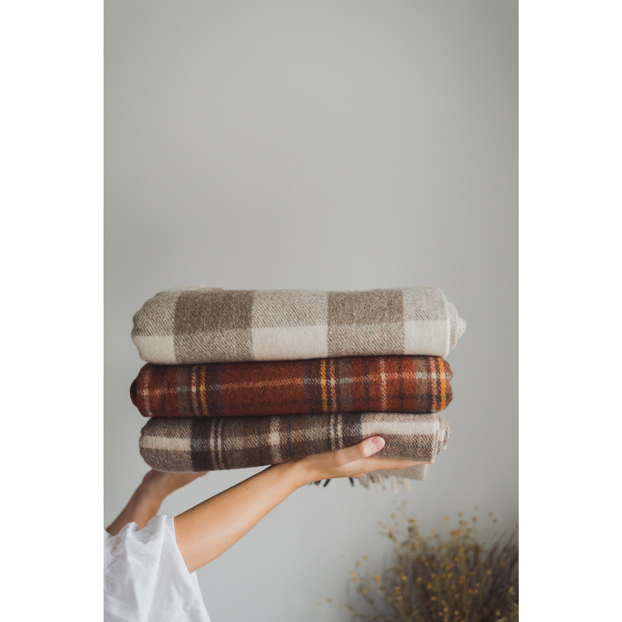 Deep Red Plaid, Cream Buffalo Check, and Brown Plaid Blanket made from recycled wool and recycled fibres. Eco-friendly wool blanket that is machine washable. Tartan Blanket Co. Festive Plaid Blanket