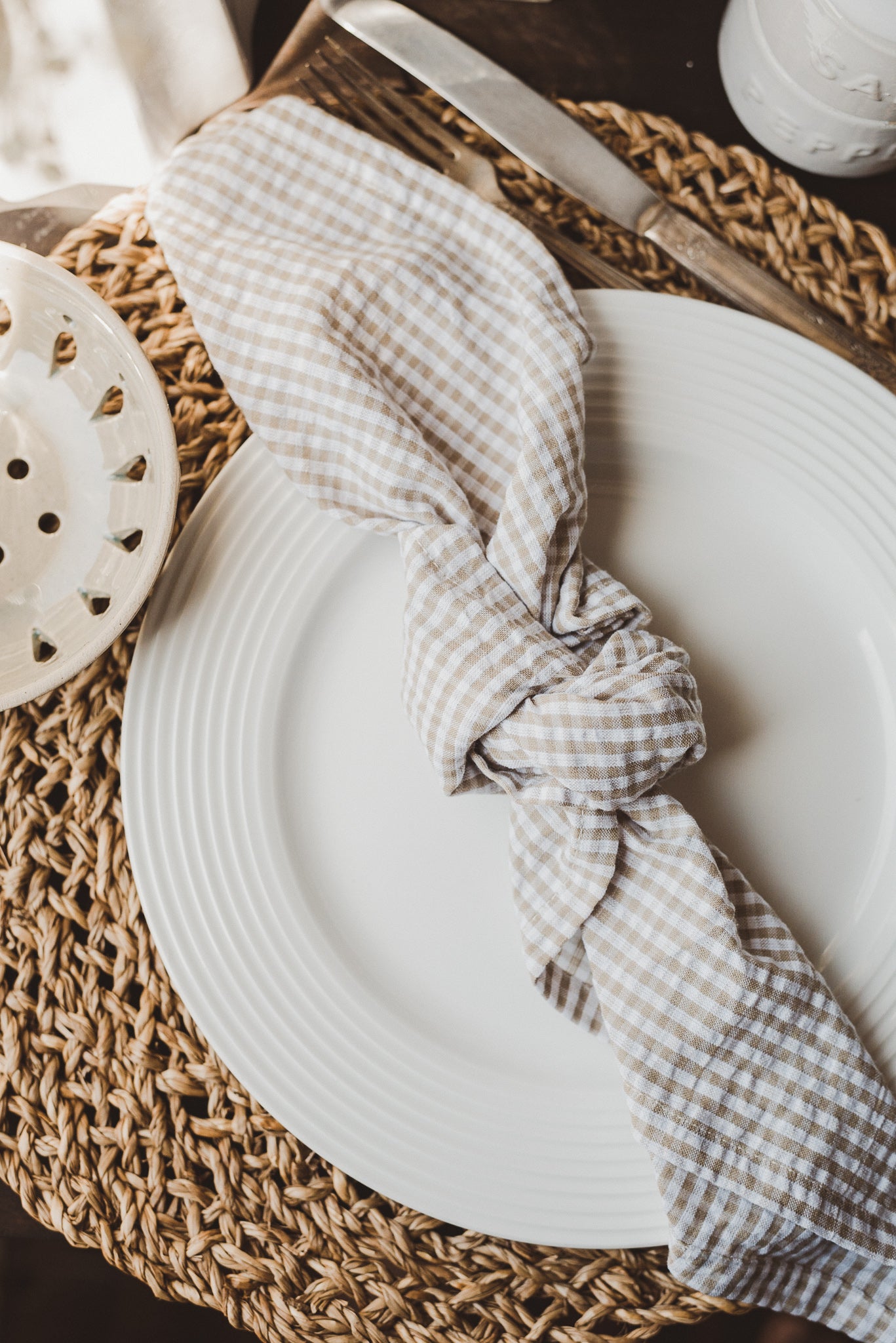 Off-white cotton with a warm neutral gingham pattern makes for a cozy yet polished everyday napkin. 