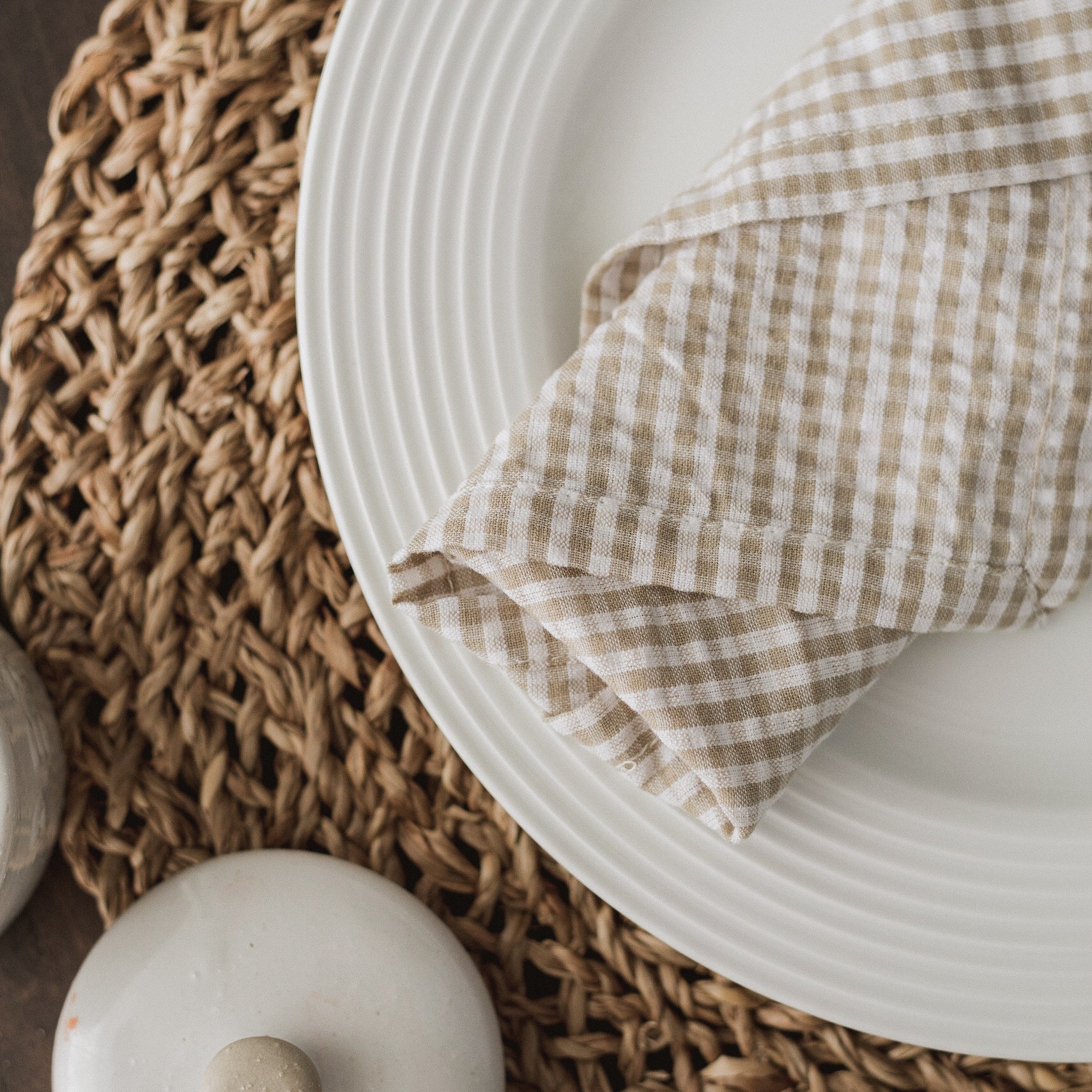 Off-white cotton with a warm neutral gingham pattern makes for a cozy yet polished everyday napkin. 