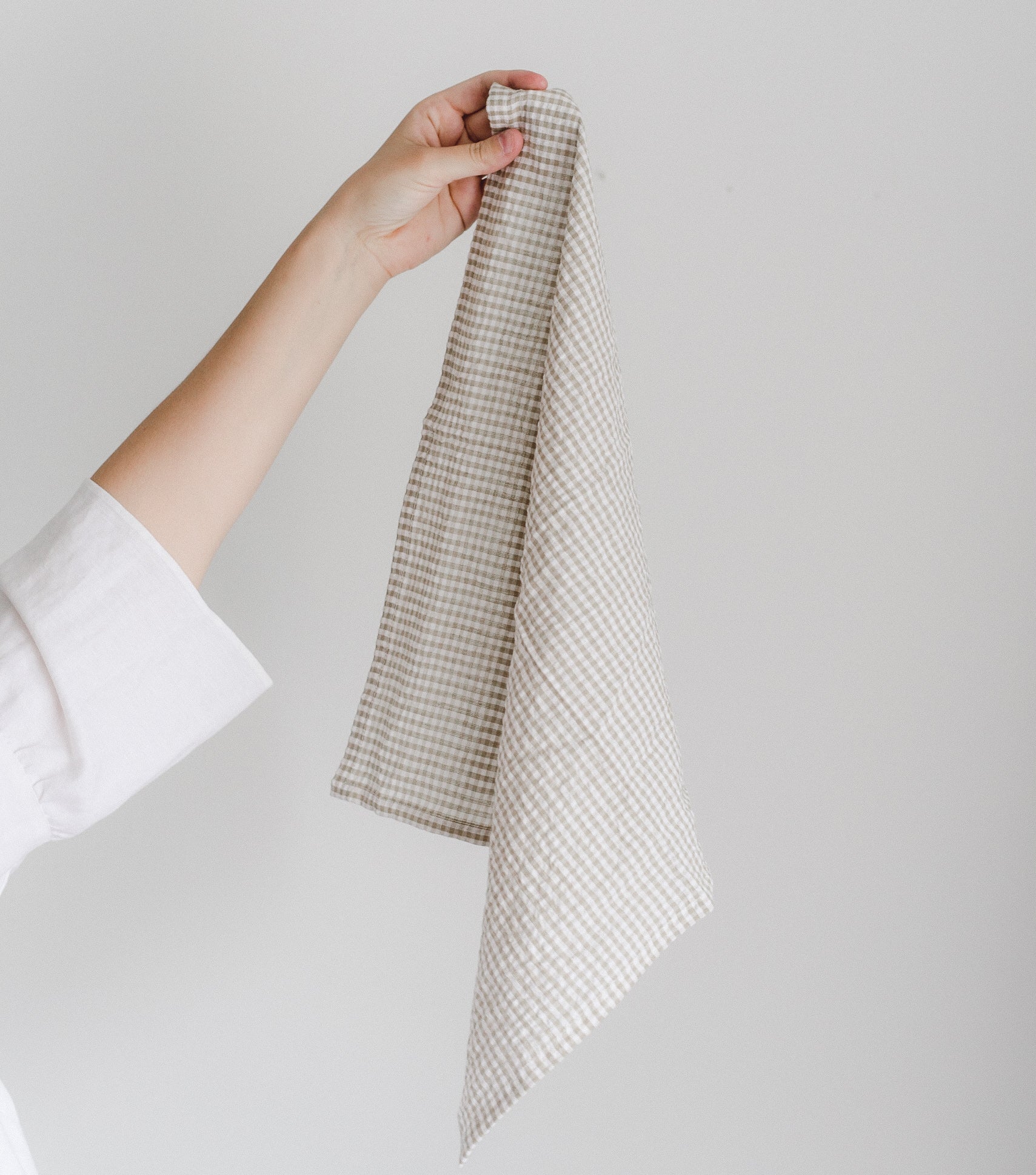 Off-white cotton with a warm neutral gingham pattern makes for a cozy yet polished everyday napkin. 