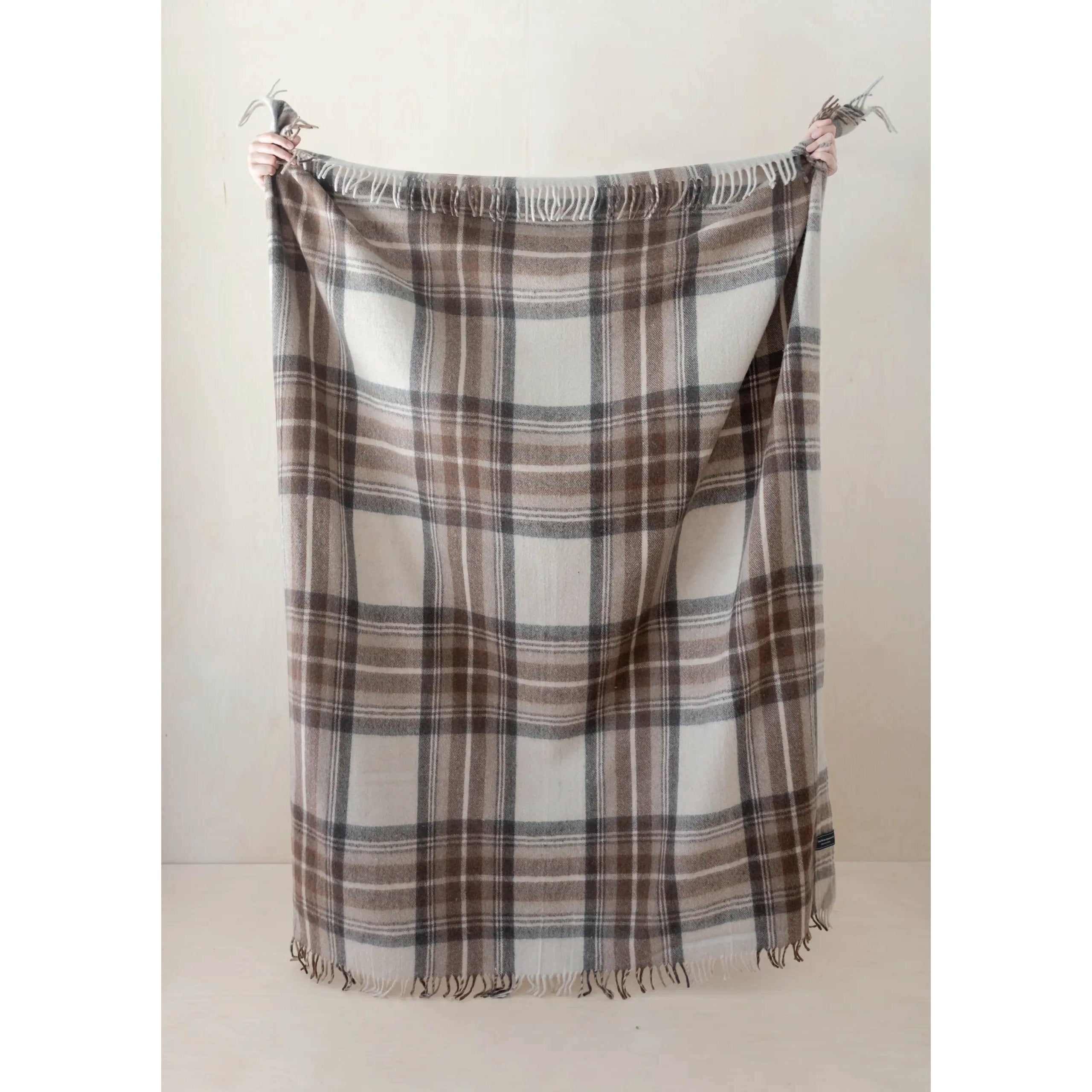Brown Plaid Blanket made from recycled wool and recycled fibres. Eco-friendly wool blanket that is machine washable. Tartan Blanket Co. Neutral Plaid Blanket. Stewart Natural Dress Tartan